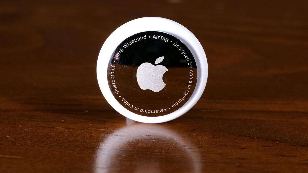 An Apple AirTag on a wooden table