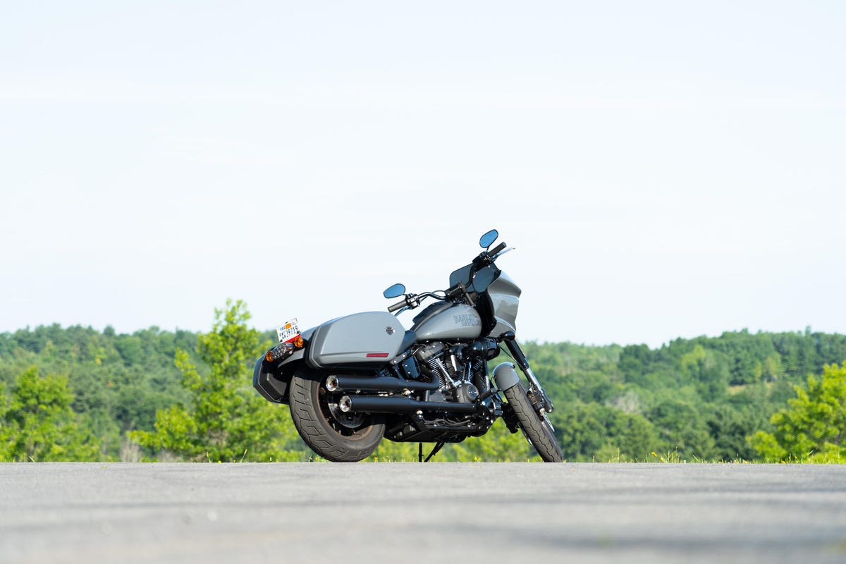 The Harley-Davidson Low Rider ST in gray, long and low with saddle bags on a bright, sunny day.