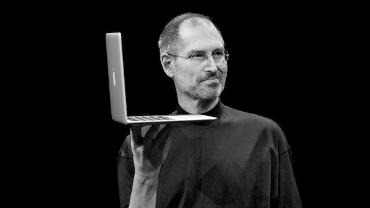 Apple CEO Steve Jobs, holding a MacBook Air