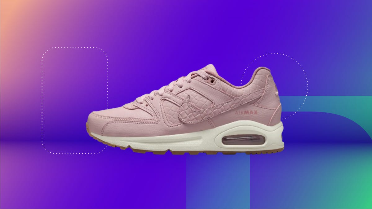 The pink Nike Air Max Command premium women&apos;s shoes are displayed against a gradient purple and blue background.