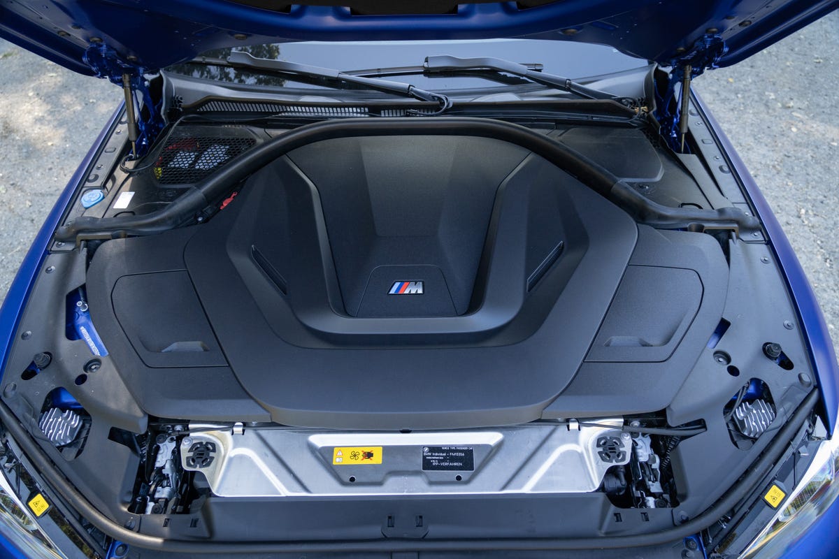 The BMW i4 M50's engine bay with large plastic cover.