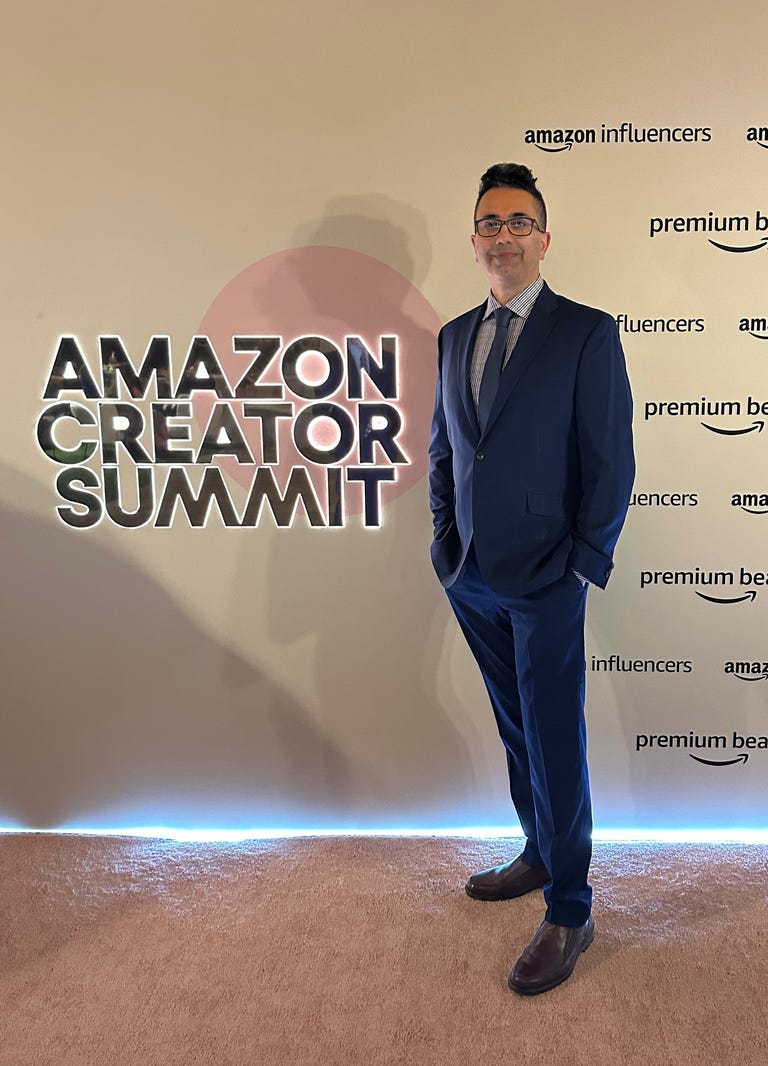 Sal Farzin stands in front of a sign that says Amazon Creator Summit