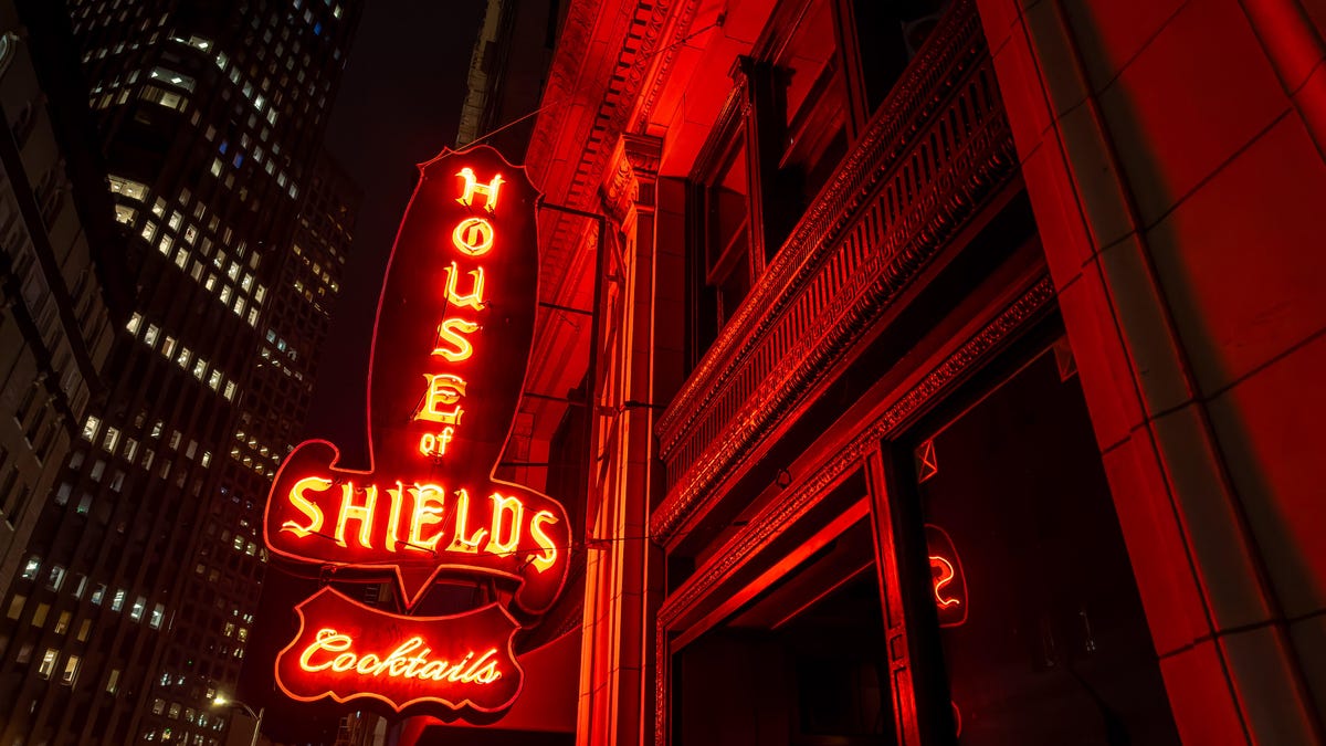 A nighttime shot of bright red neon lights in San Francisco with the illuminated words "House of Shields" lighting up the front of a building