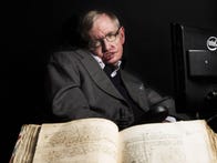 <p>Stephen Hawking pictured with Isaac Newton's own annotated copy of "Principia Mathematica."</p>