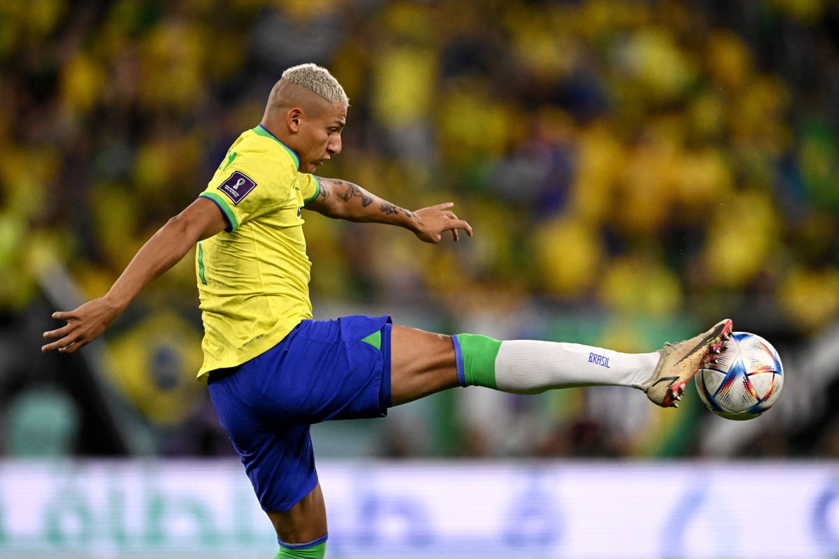 Brazil's Richarlison performs a high kick.