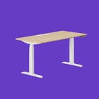 White legged standing desk with wood top on a purple background