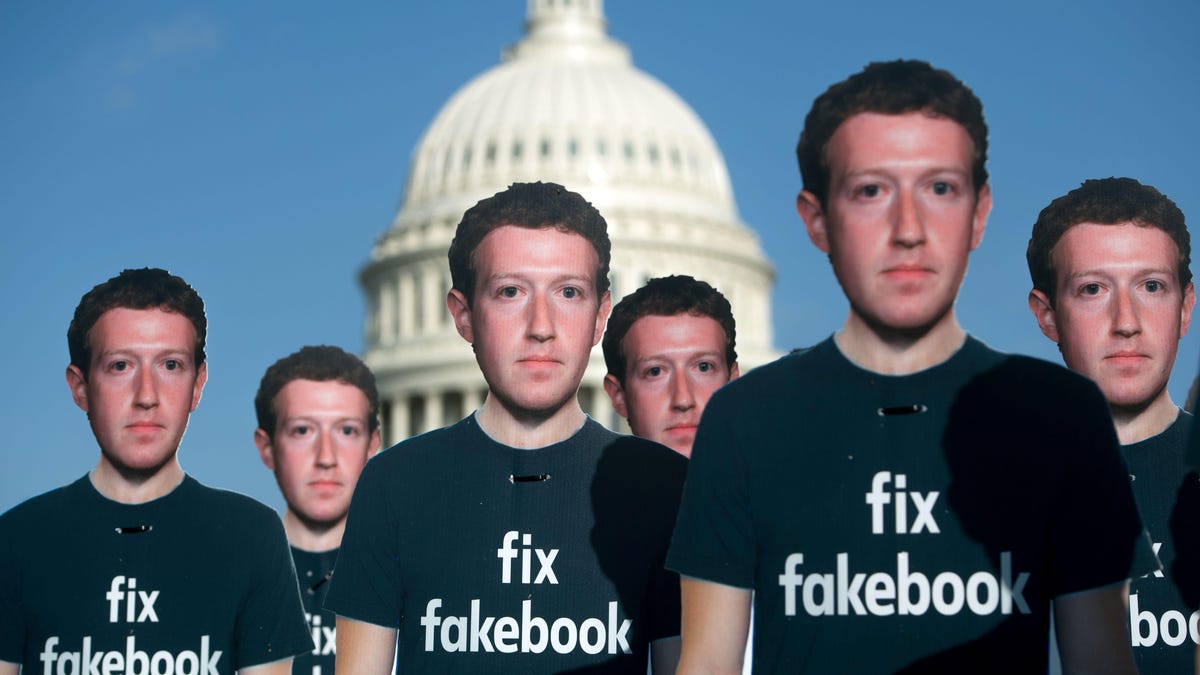 In front of the US Capitol building, cardboard cutouts of Mark Zuckerberg wearing a T-shirt that reads "fix facebook."