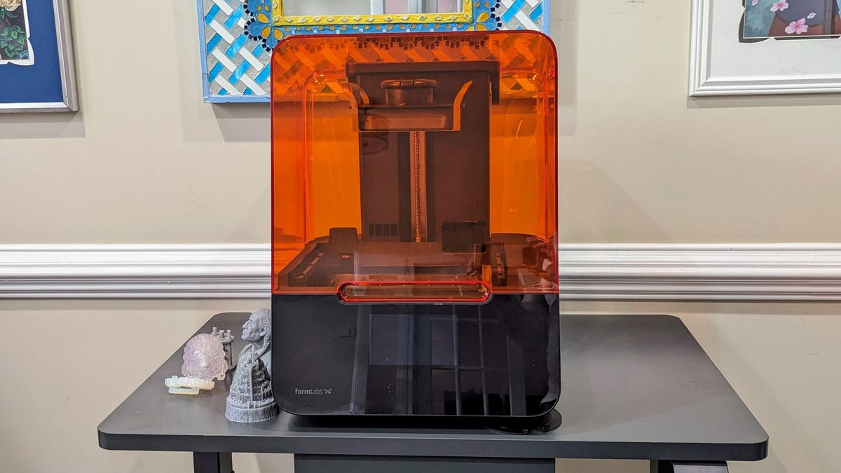 The Formlabs form 3 plus on a table with 3d printed models next to it