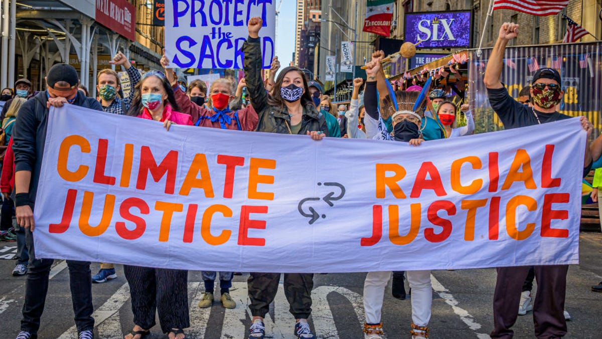 Protestors in NY holding "climate justice equals racial justice" banner