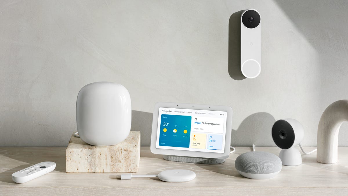 An assortment of Google's Nest smart home products on a table, including the new Nest Wifi Pro mesh router and the wired Nest Doorbell.