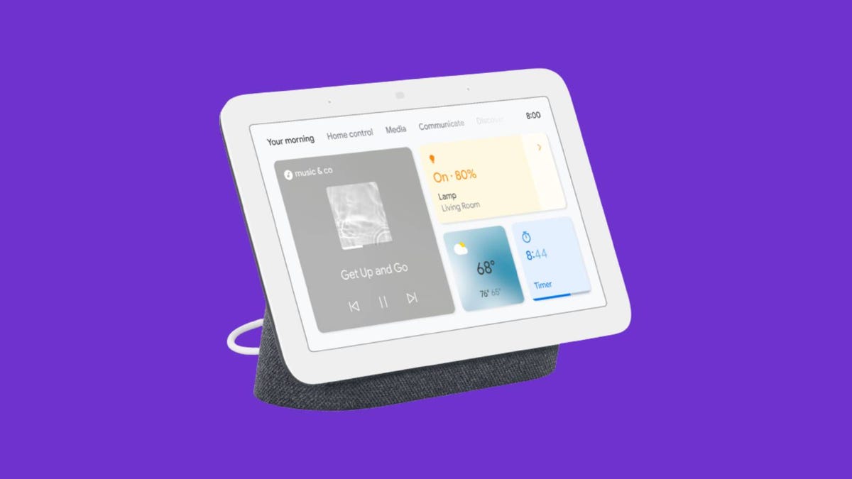 A second-gen Google Nest Hub smart display against a purple background.