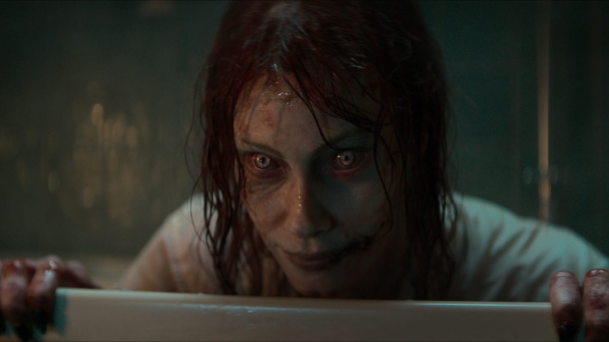 Alyssa Sutherland as a demonic figure rising from a bath in in Evil Dead Rise.