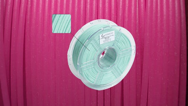 A roll of minty filament on a pink background