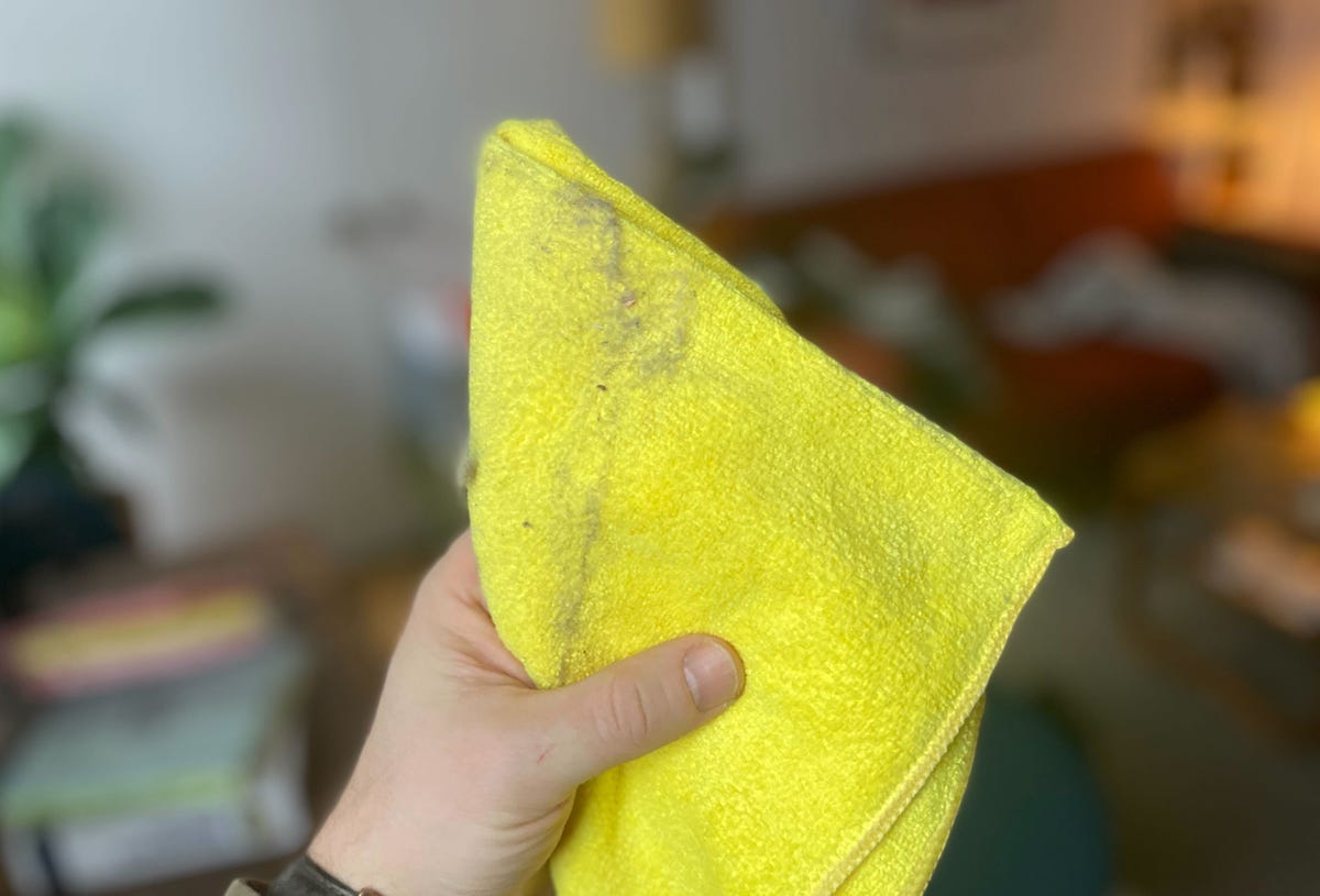 hand holding dusty microfiber cloth