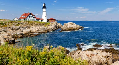 A bright summer afternoon at Portland Head Lighthouse in Fort Williams Park on Cape Elizabeth in Portland, Maine.