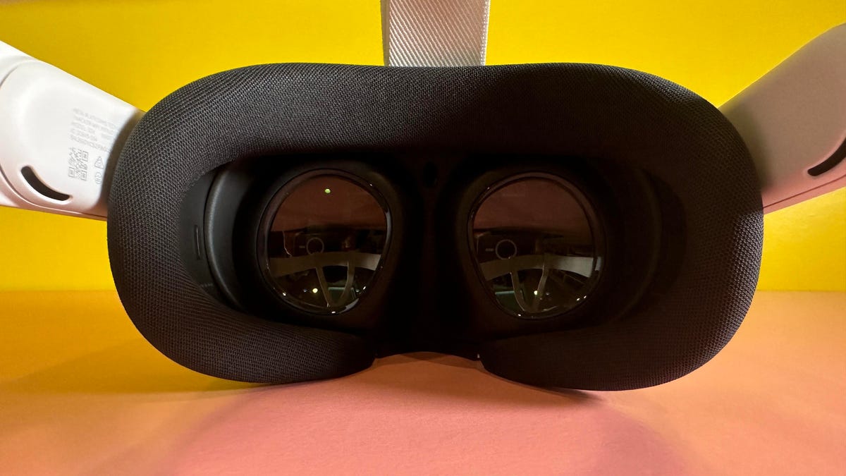 Looking at a VR headset&apos;s lenses on a pink table