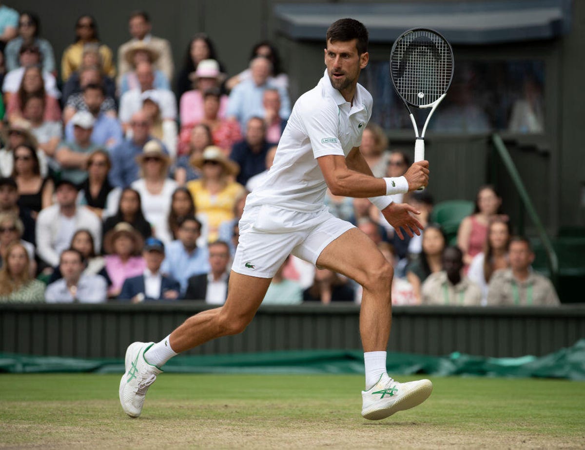 Novak Djokovic goes to play a backhand at Wimbledon