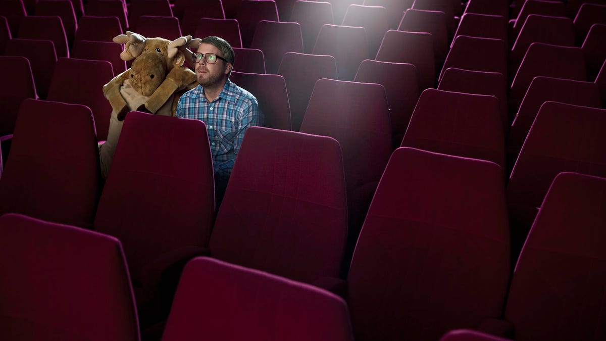 Man on a date at the movies, with a moose