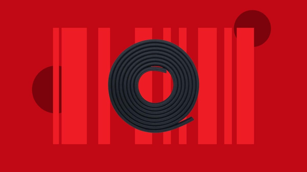 A coil of black rubber weatherstripping on a red background.
