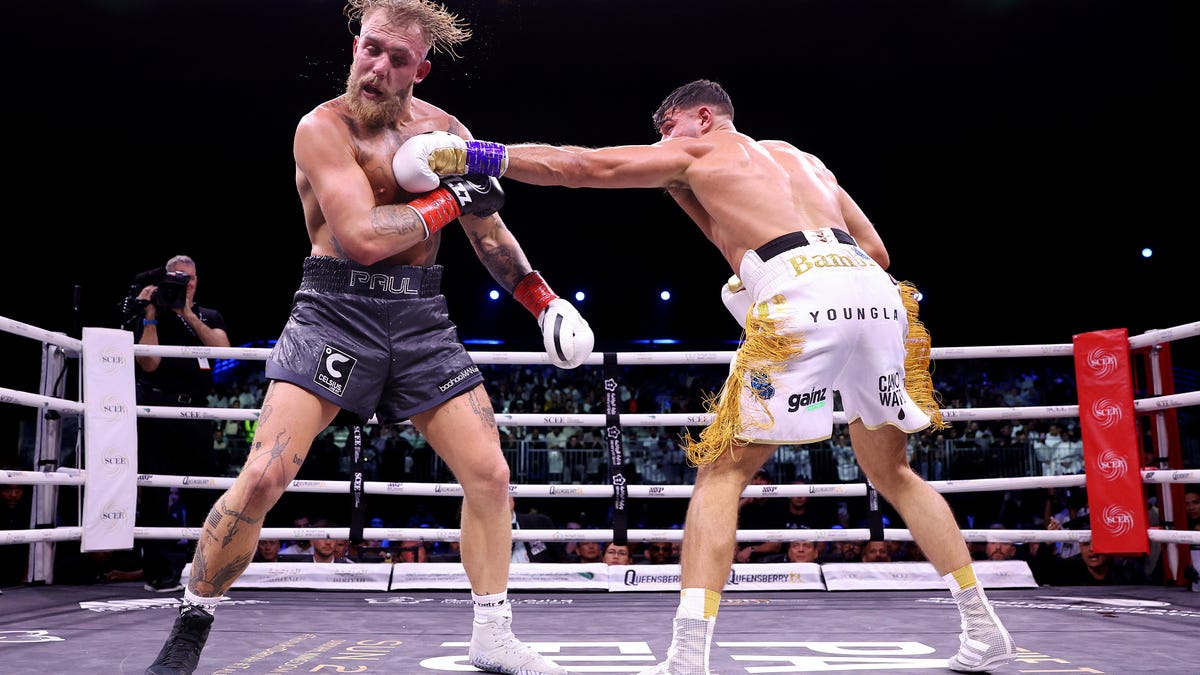 Jake Paul being hit by a left jab from Tommy Fury.
