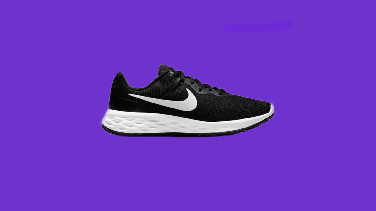 One black and white Nike shoe on a purple background