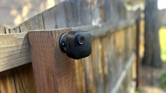 The Blink Outdoor 4 camera connected to a wooden fence post.