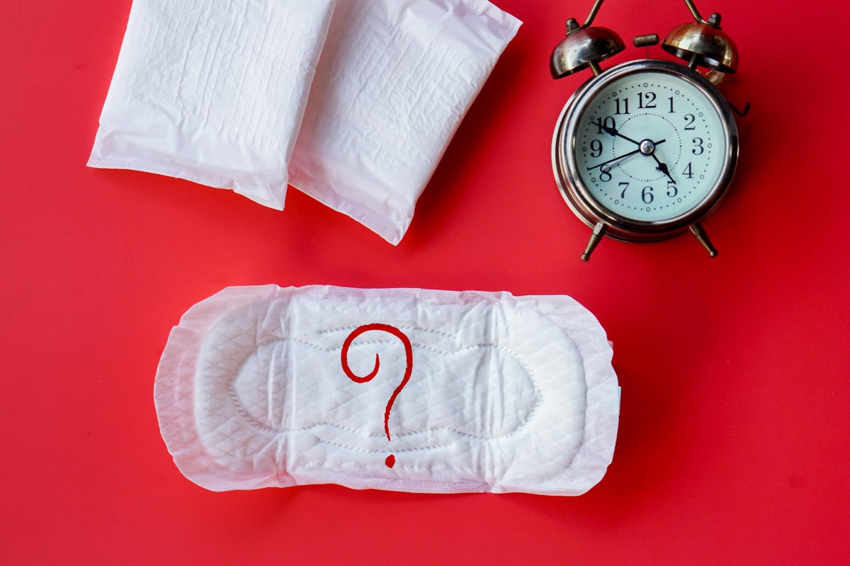 Pads and a clock against a bright red background.
