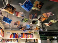 <p>Once you step through the book hole, you'll see many more fluttering above you as you wander through the bookstore part of this shop.&nbsp;</p>