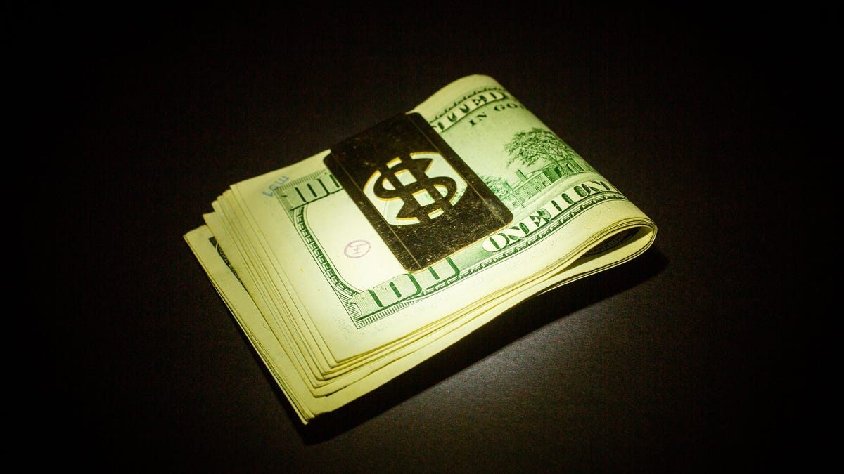 005-money-cash-dollar-bills-hundreds-spotlight-black-background-money-clip-stimulus-check-bill-savings-poverty-hope
