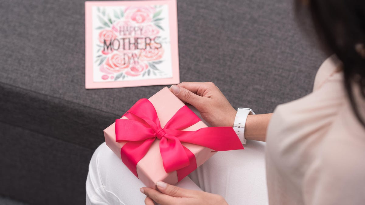 cropped image of african american mother opening present on mothers day
