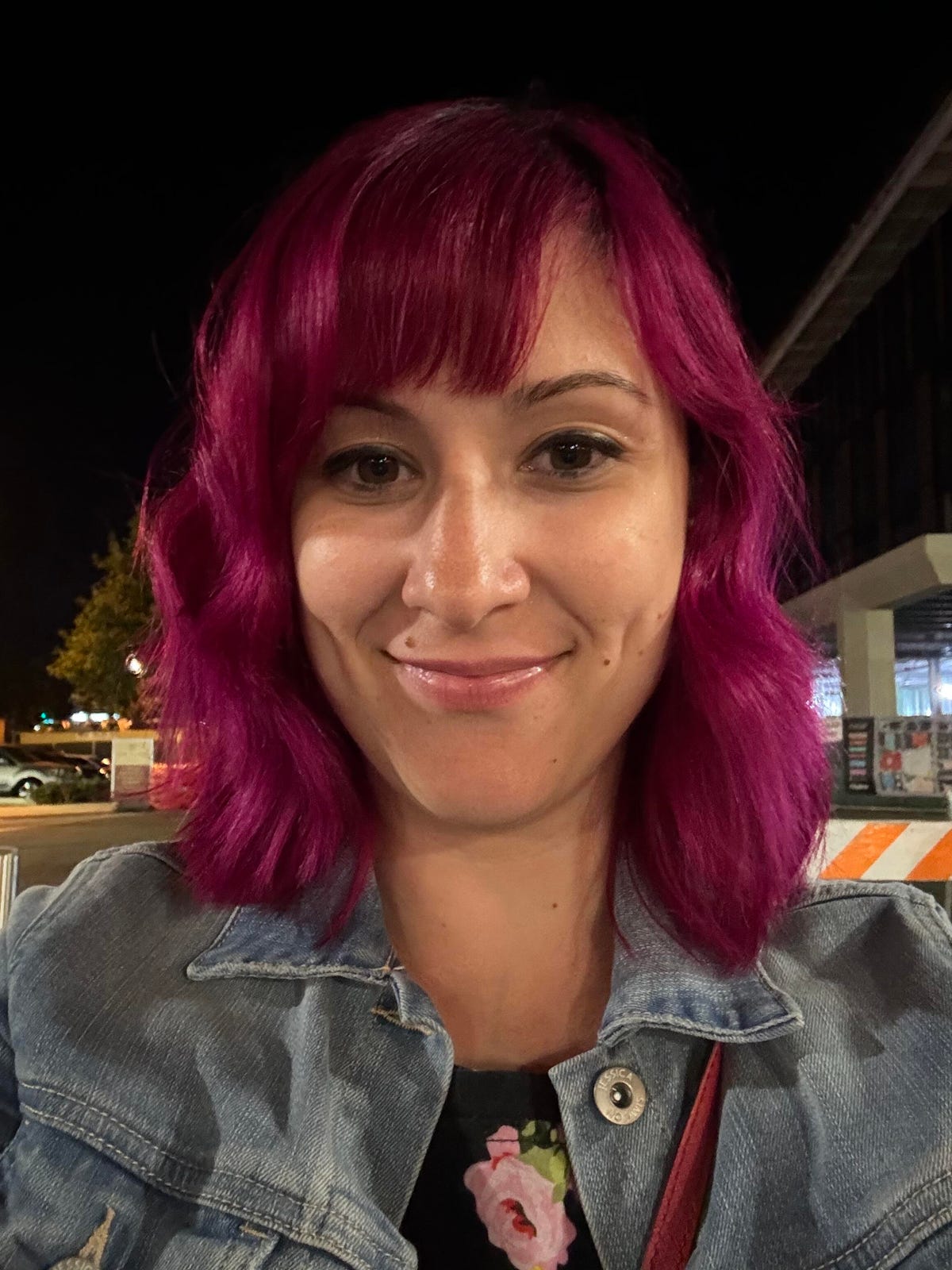 A photo of a woman with pink hair taken on the iPhone 15.