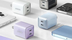 Four Anker 521 chargers are displayed near phones on a flat surface.