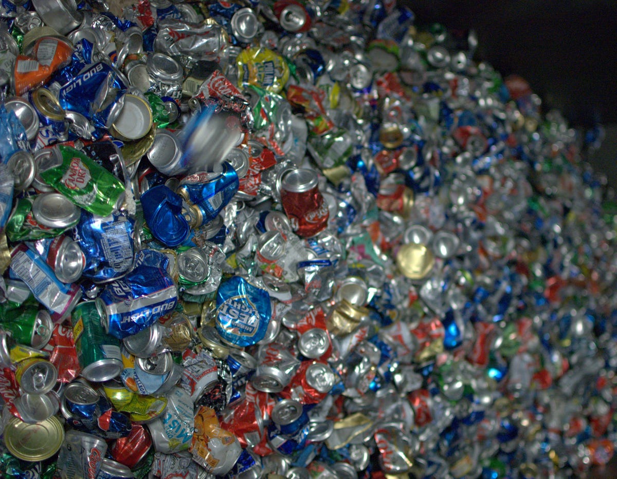 Crushed aluminum cans, automatically separated from mixed recycling, await the compressor where they will be packaged as giant bales and sold to mills.
