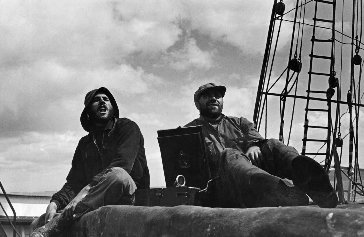 Merchant sailors on a sailing ship, with early record player