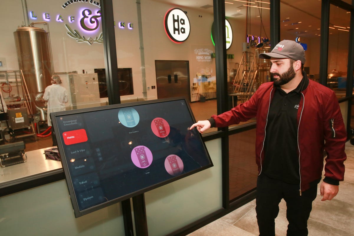 If you walk further down the hallway, you can look through a glass wall and watch edibles being made. This touchscreen kiosk offers information about all the brands and products.