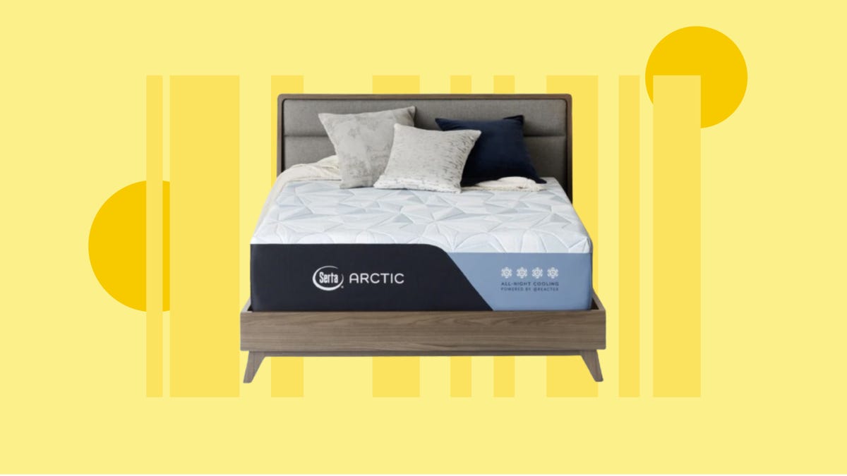 The Serta Arctic mattress is displayed on a bed base and with pillows against a yellow background.