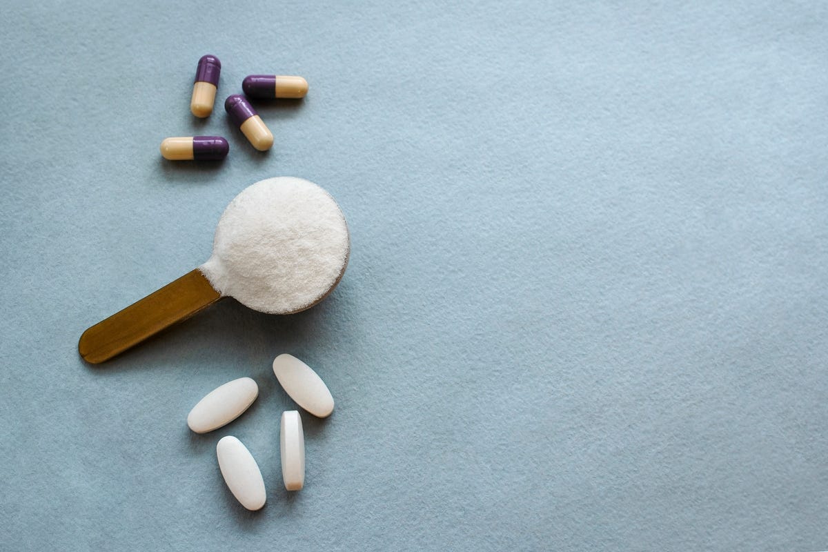 Three types of collagen in powder tablets and capsules on a gray background