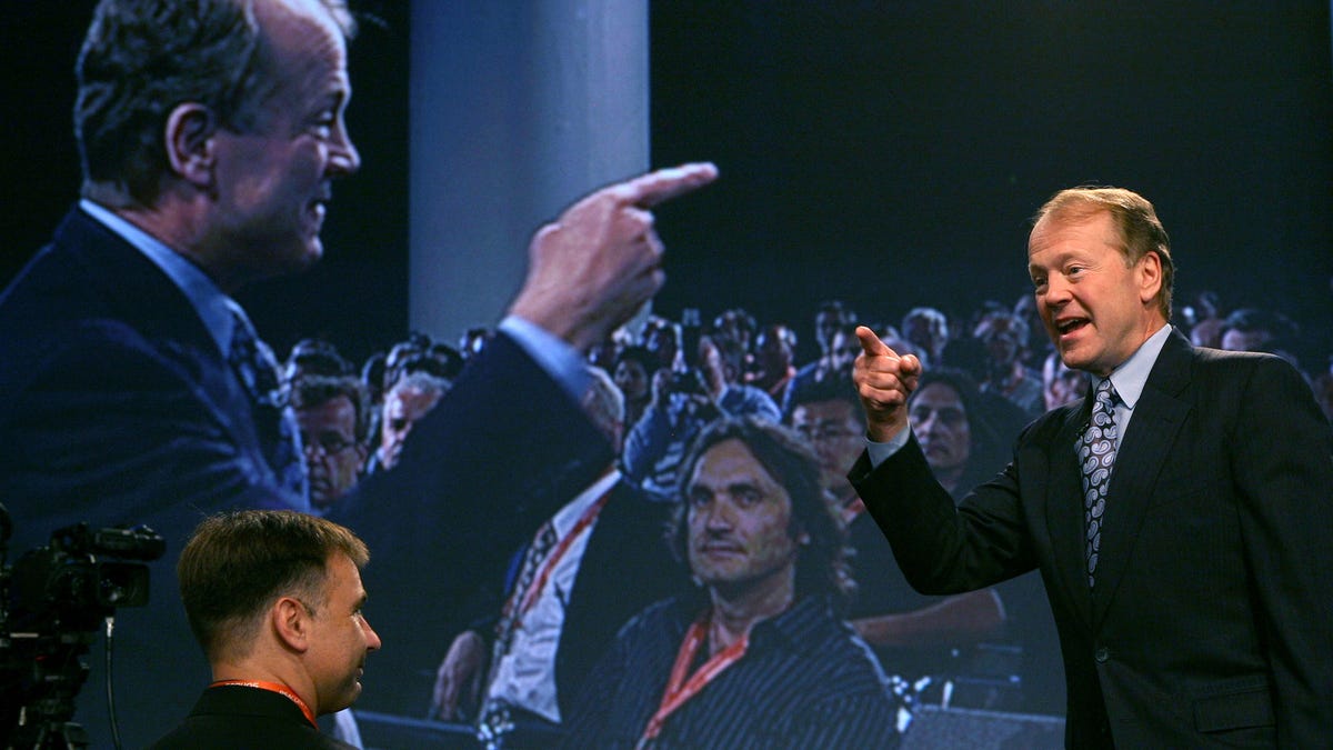 Cisco Chairman and CEO John Chambers delivers a keynote address during the RSA Conference in 2009. Chambers stands to the right, pointing. Behind him, a video screen shows his mirror image pointing back at him. This year, 19 out of 20 keynote speakers will be men.