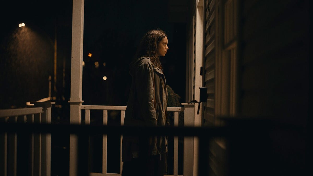 Georgina Campbell stands on the porch of a house in Barbarian.