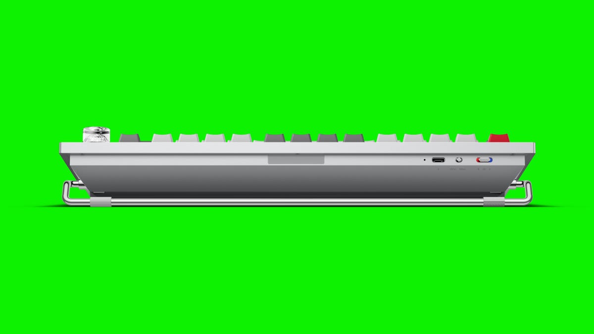 The back of the OnePlus Feature Keyboard 81 Pro mechanical keyboard against a green background.