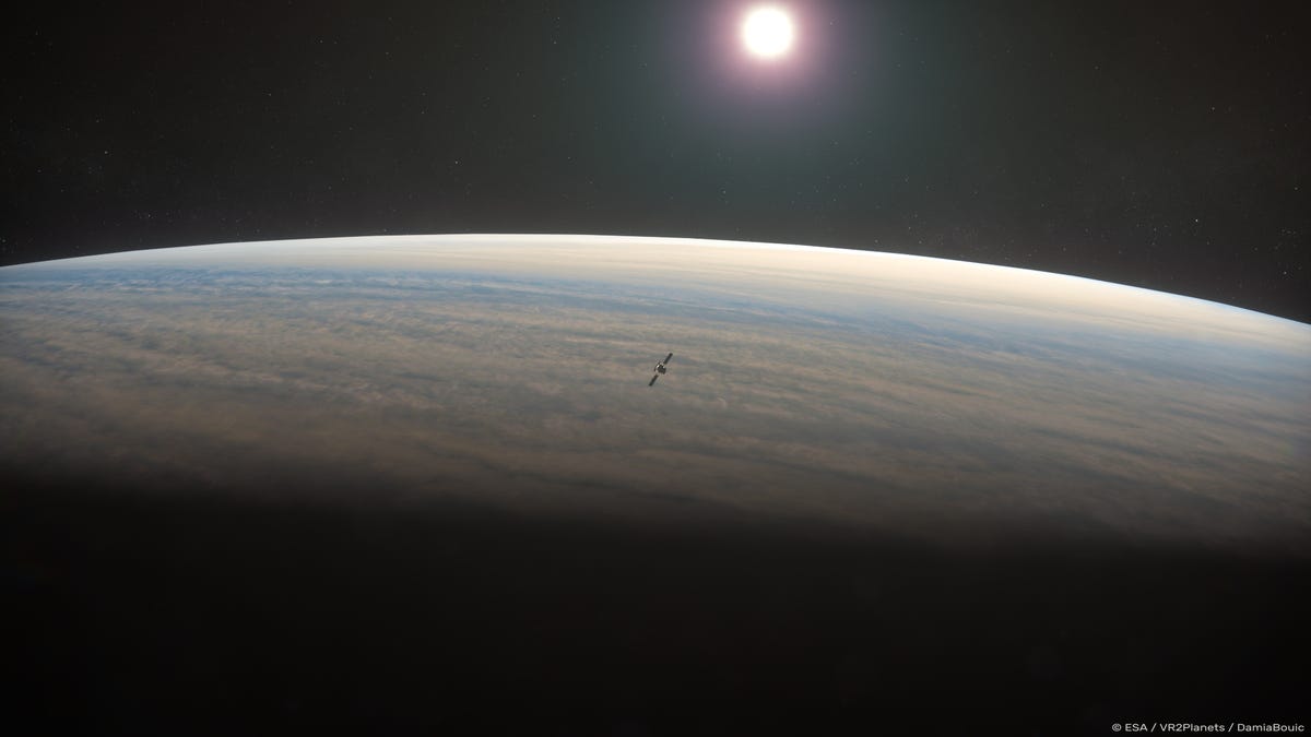 A zoomed-in view of Venus, where you can still see its curvature, against space's dark background. The sun shines in the distance and a tiny spacecraft is seen floating above the planet's atmosphere.