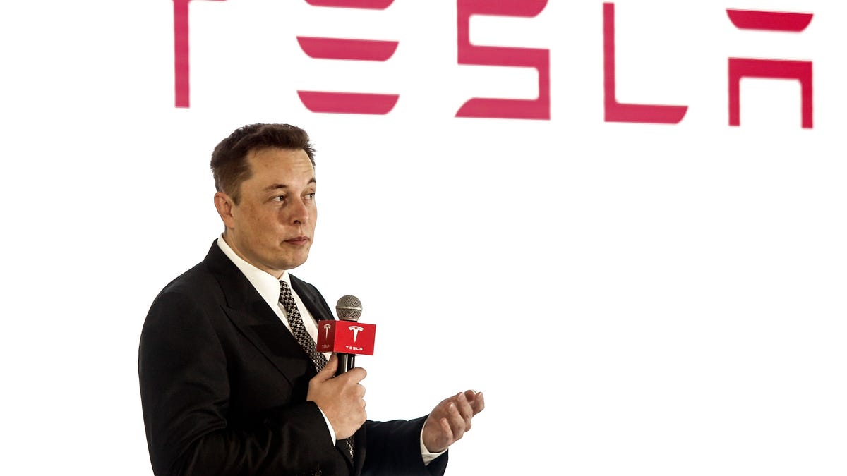 Elon Musk presenting at a Tesla event.