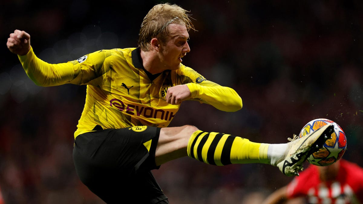 Julian Brandt of Borussia Dortmund striking the ball with his right foot.