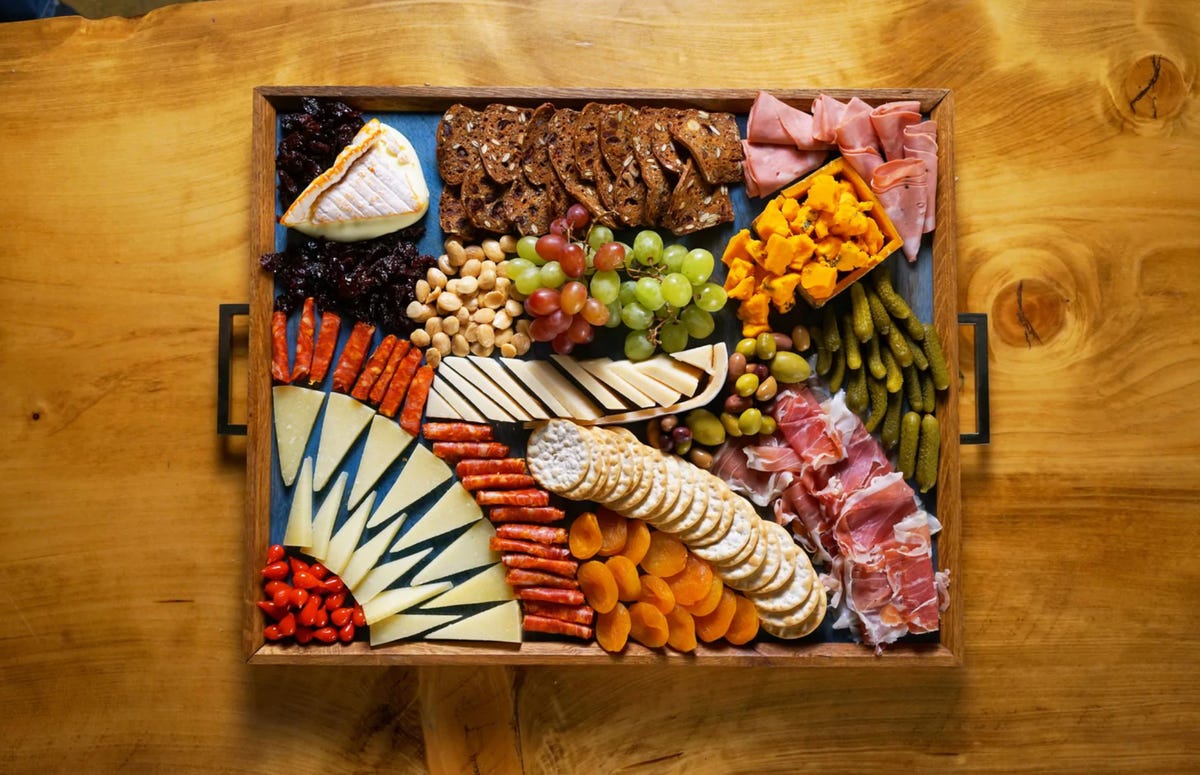 An artfully arranged cheeseboard with charcuterie and crackers