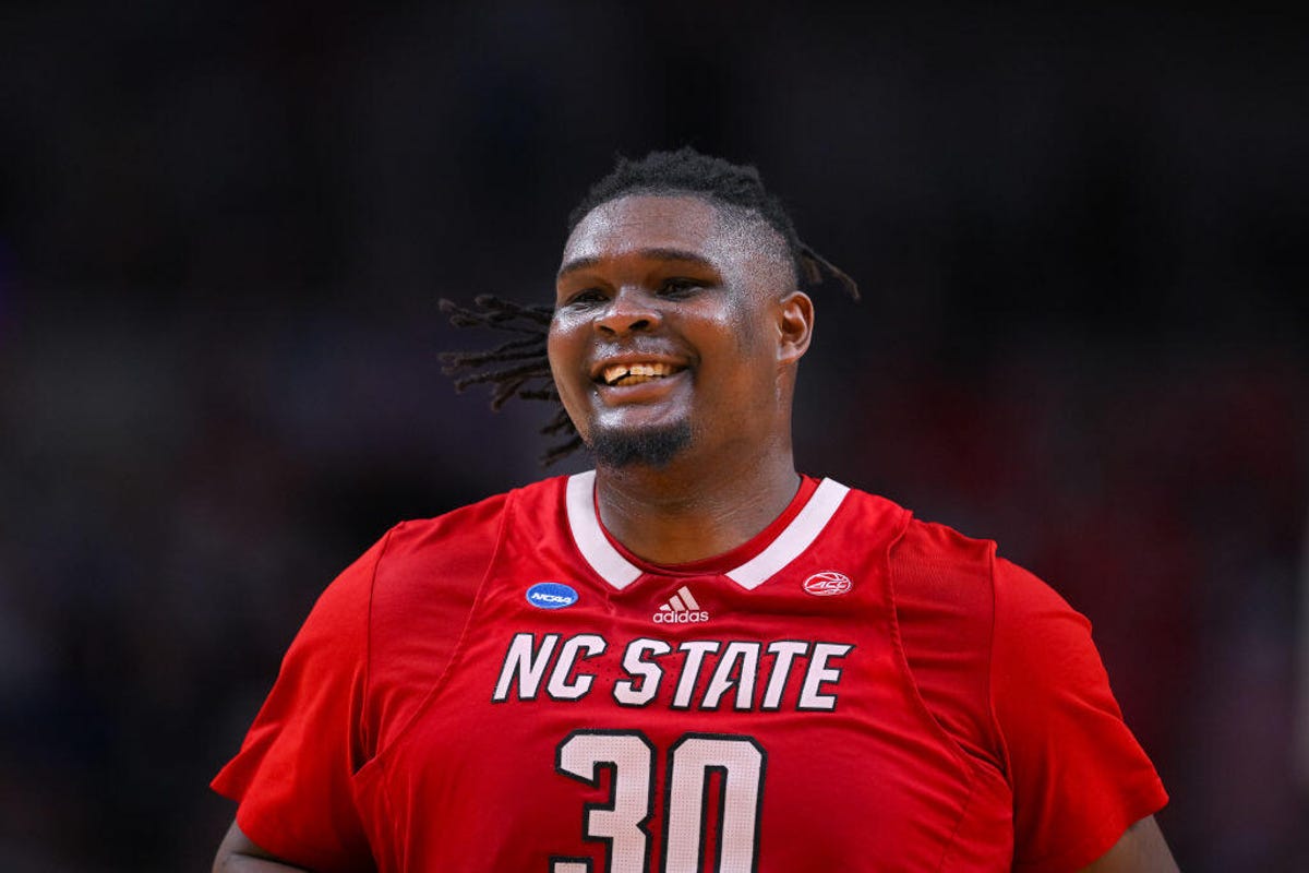 NC State big man DJ Burns Jr. smiles down the court during the Elite Eight round of the 2024 NCAA Men's Basketball Tournament