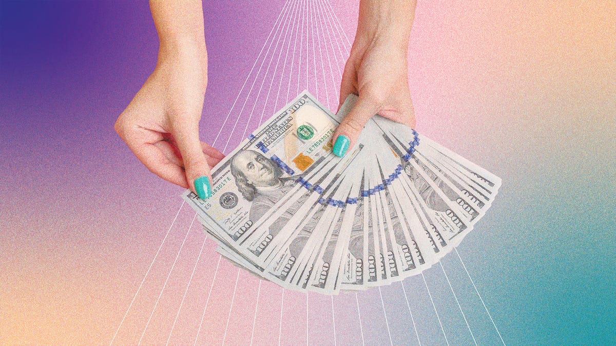 a pair of hands flipping through dollar bills, in front of a purple and green background