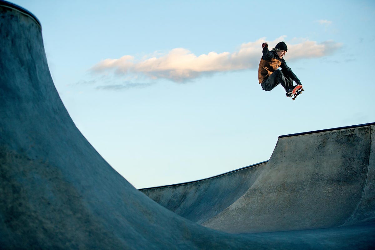 Skateboarder jumping at a skate park.