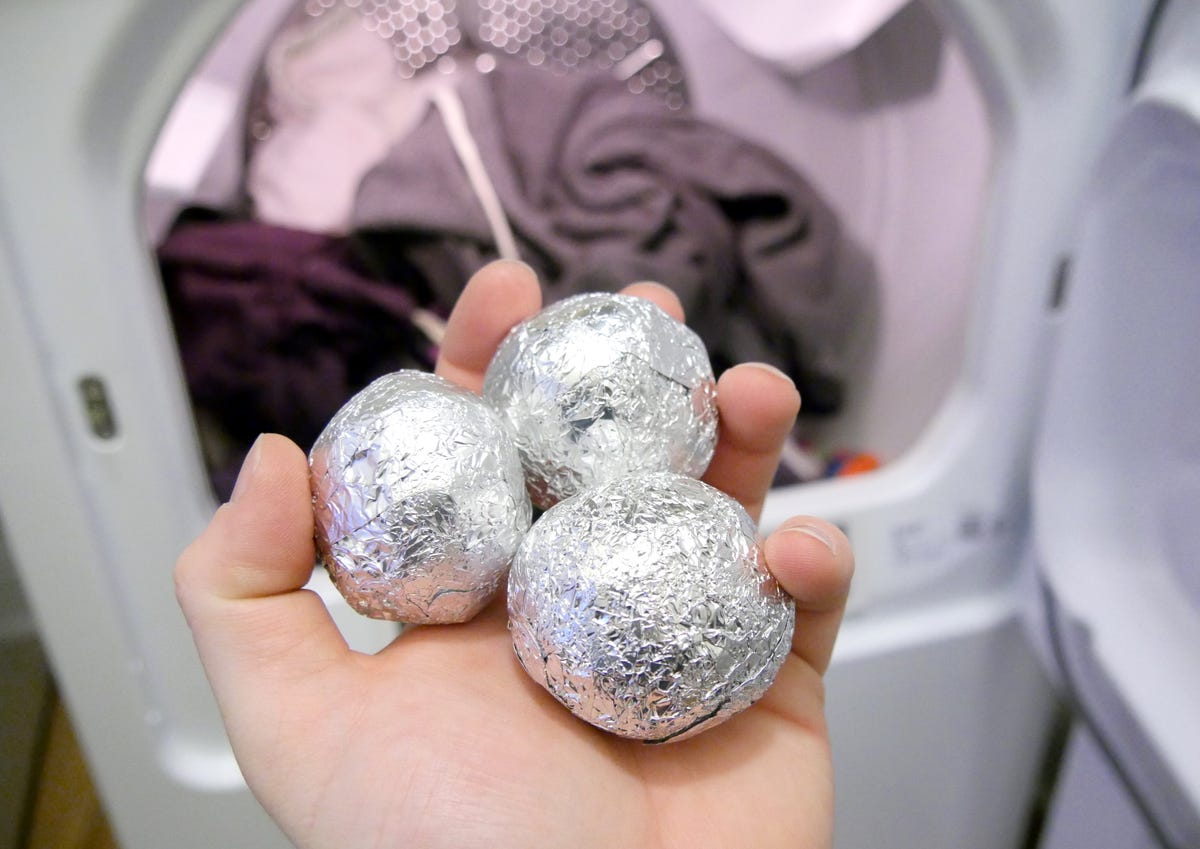 aluminum foil balls going into laundry