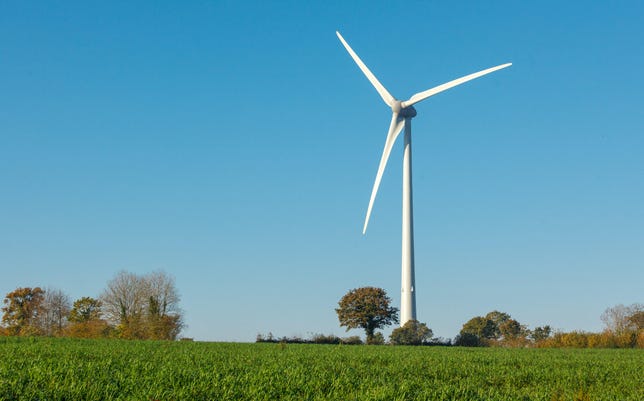 Wind turbine above a grassy field