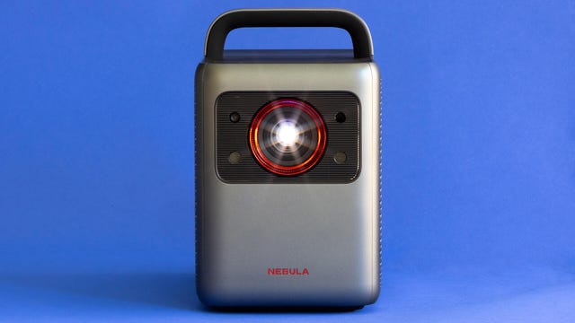 An Anker Nebula Cosmos projector against a blue background.